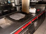 une cuisine équipée d'une cuisinière, d'un évier et d'un four