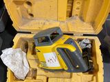 a yellow case with a tool in it on the floor