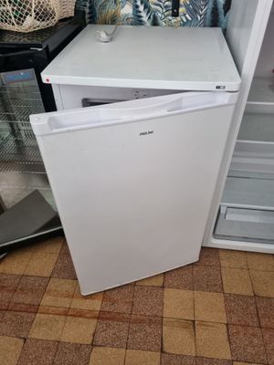 a white refrigerator with a door open in a kitchen