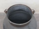 a pot that is sitting on the ground by the wall