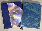two notebooks that are sitting next to each other on a table