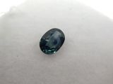 an oval blue sapphire stone on a white surface