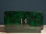 an image of a green cabinet sitting on top of a wooden table