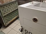 a white refrigerator sitting on a cart in the middle of a room