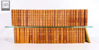 a stack of books sitting on top of a glass shelf