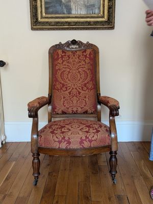 a woman standing next to a chair in a living room