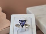 a white box with a ring inside of it on a table