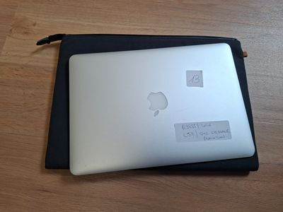 a laptop with a sticker on it sitting on a table