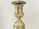a gold vase that is sitting on a table