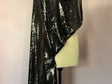a black sequinned shawl on a mannequin stand