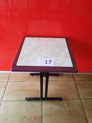 red and white table with a number on it in front of a red wall