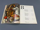 une image représentant un livre sur lequel figure une image représentant un panier et des pommes
