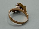 a close up of a ring with a flower on it