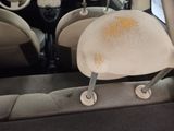 a dirty seat in the back of a car