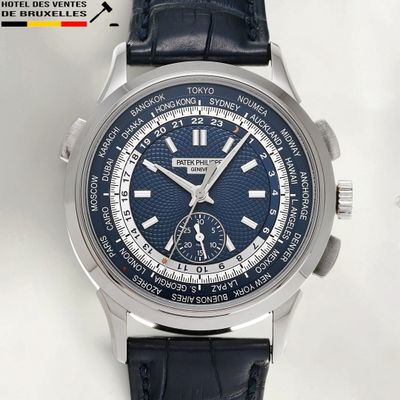 a close up of a wrist watch with a blue dial