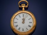 an old gold pocket watch with roman numerals on the face