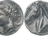 a silver coin with an image of a woman and a bird on it