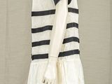 an image of a mannequin wearing a white dress with black stripes