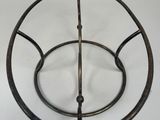 a metal object that is sitting on a white surface