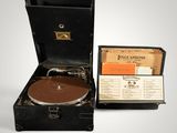 an old record player sitting in a suitcase with a record in it
