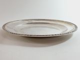 silver plate with a beaded edge sitting on a white surface