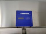 a blue sign on the side of a stainless steel refrigerator