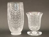 two glass vases sitting next to each other on a table