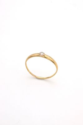a close up of a gold ring with a diamond on it