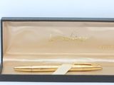 an image of a pen in a box with a ribbon around it