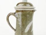 a close up of a coffee pot on a white surface