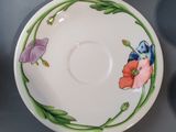 a cup and saucer sitting on a table next to a plate
