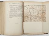 an open book with a map on it sitting on top of a table
