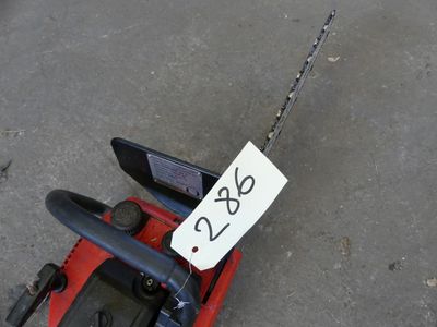 a red toy car with a sign attached to it