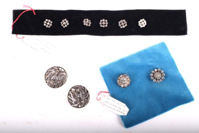 a blue cloth with silver buttons on it and a blue cloth with silver buttons on it