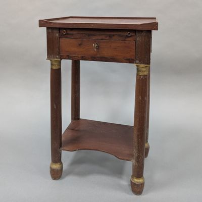 an old wooden table with a drawer on top of it
