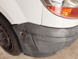 a close up of the front bumper of a white van