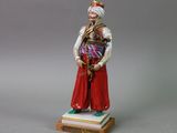 figurine of a man dressed in traditional clothing and a turban