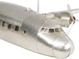 a silver model of an airplane on a white surface