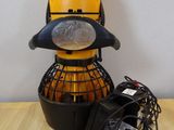a yellow and black object sitting on a table next to a charger