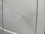 a white car with a hole in the side of it