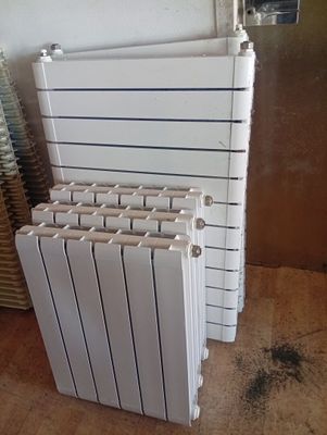 several white radiators stacked on top of each other in a room