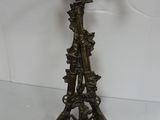 bronze figurine of a bird on a tree branch with a bird perched on top of it