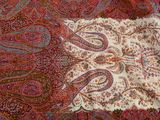 a close up of a paisley pattern on a table cloth