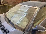 a car that is parked in front of a brick wall