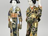 two asian figurines of women dressed in traditional clothing