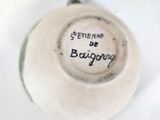 a close up of a white vase with a black writing on it