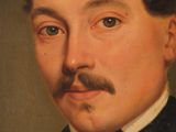 portrait of a man with a mustache in a suit and bow tie