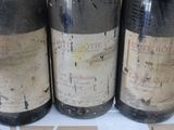 three bottles of wine sitting on a counter top