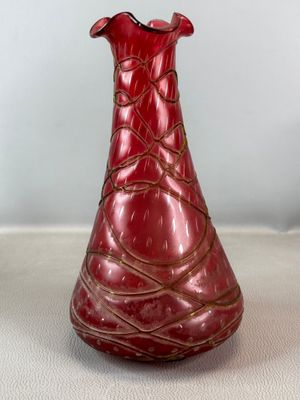 a red vase that is sitting on a table