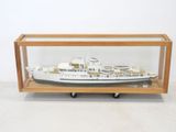 wooden display case with a model of a ship inside of it